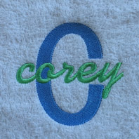 embroidered boys name in cursive on baby blanket with white trim